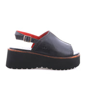 The Bed Stu Library is a black open-toe platform sandal with an adjustable ankle strap, thick black sole, and brown trim detail for a '90s retro vibe, shown against a white background.