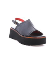 Bed Stu Library black open-toe platform sandal features a thick sole, adjustable ankle strap, and red interior lining for a '90s-inspired look. Displayed on a white background.