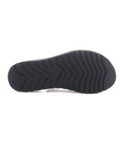 The image shows the black, textured rubber sole of Bed Stu's Library platform sandal with a zigzag tread pattern—ideal for bringing '90s nostalgia and retro style to your look.