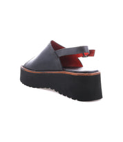 The Bed Stu Library is a black open-back platform sandal with a thick, ridged sole and adjustable heel strap, offering '90s nostalgia and retro style, shown on a white background.