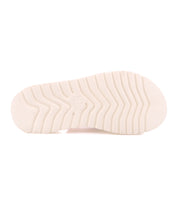 The image shows the bottom view of the Bed Stu Library sandal in white, featuring a platform sole with deep, angled grooves for traction—a retro-inspired nod to '90s nostalgia.