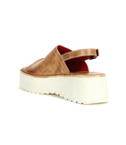 The Bed Stu Library is a tan leather platform sandal with a thick white sole and back strap, shown from the rear—perfect for adding '90s nostalgia and retro style to any outfit.