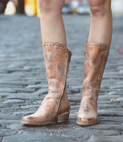 woman in tan mid calf boot
