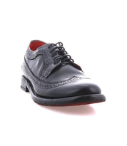 The Bed Stu Lita K II is a single black leather wingtip shoe with decorative perforations, red interior lining, and black laces, shown on a white background.
