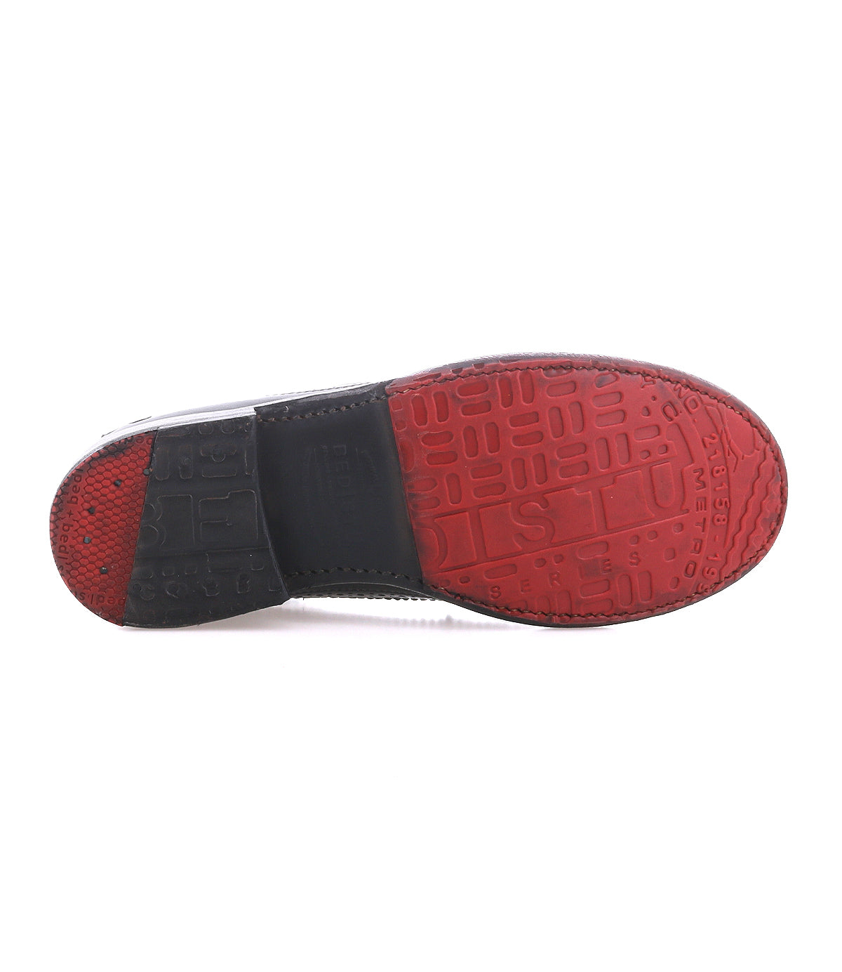 The Bed Stu Lita K II shoe features a red and black sole with textured tread, raised lettering, and brogue details inspired by classic derby and wingtip styles.