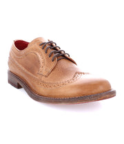 The Bed Stu Lita K II is a brown leather brogue shoe with decorative perforations, a wingtip design, and a lace-up pattern. It features a classic derby silhouette and low heel, shown from a side angle against a white background.