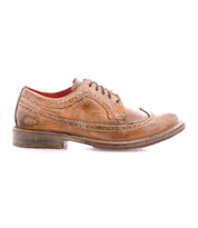 The Bed Stu Lita K II is a single brown leather classic derby wingtip shoe with visible wear, detailed brogue stitching, and dark laces, shown in profile on a white background.