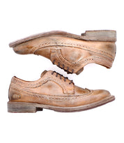 The Bed Stu Lita K II features worn brown leather in a classic derby style, visible stitching, and scuffed soles. Shown in a side view with one shoe above the other.