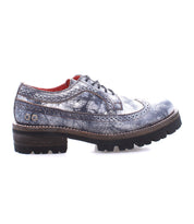The Lita K III by Bed Stu, a single gray and black brogue shoe featuring a rugged sole, side view, exudes retro chic sophistication while offering a nod to 90's fashion.