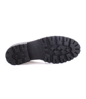 The image highlights the bottom view of the Lita K III black boot sole by Bed Stu, featuring a textured, rugged tread pattern that exudes a retro chic vibe.