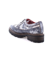 The Lita K III by Bed Stu, featuring distressed leather, thick chunky soles, and visible stitching, exudes a retro chic vibe when viewed from the back angle.
