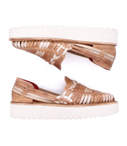 The Bed Stu Lizzie is a pair of hand-woven leather slip-on platform huarache shoes with thick white durable outsoles, displayed in side profile against a white background.