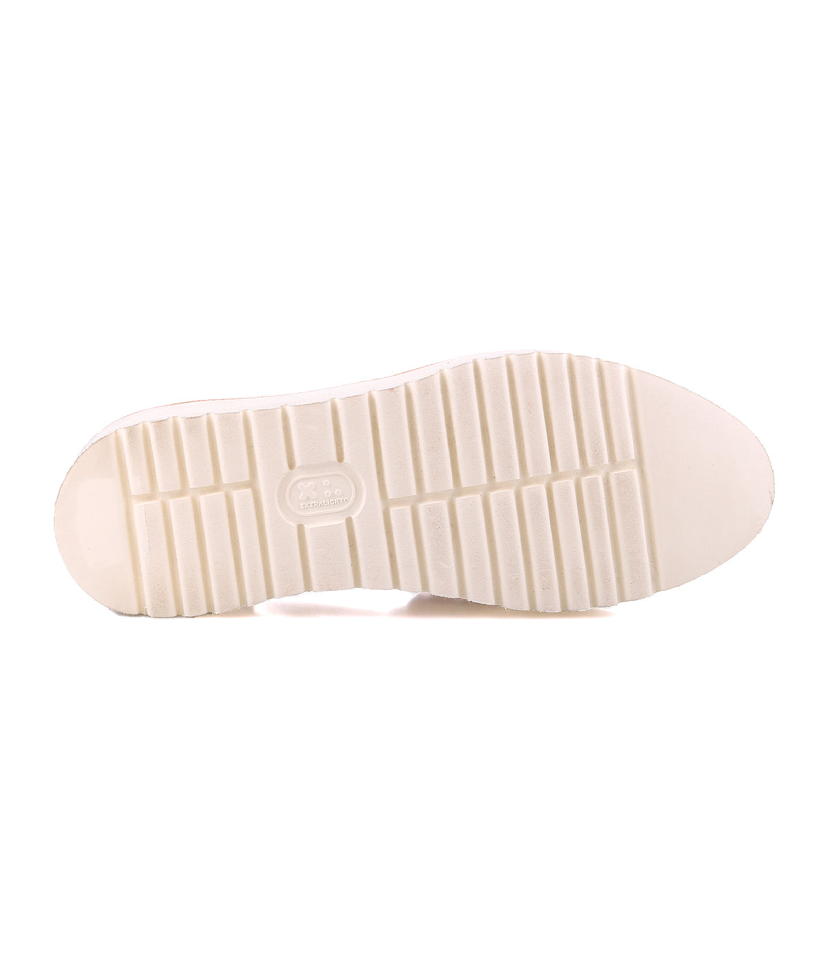 The image shows the bottom view of the Bed Stu Lizzie white rubber shoe sole, featuring a rectangular tread pattern, a small oval label at the center, and a durable outsole inspired by classic platform huarache styles.