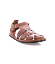 The Bed Stu Lone is a brown distressed leather strappy sandal with multiple straps, an antique brass buckle on the side, and a flat sole, shown angled against a white background.