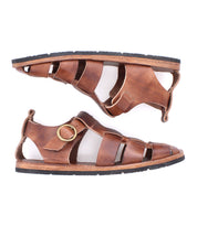 The Bed Stu Lone sandals feature brown distressed leather uppers, black soles, and an antique brass buckle on the strap, shown in a side profile view.