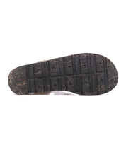 The image shows the worn sole of the Bed Stu Lone black strappy sandal, featuring visible tread patterns and signs of use.