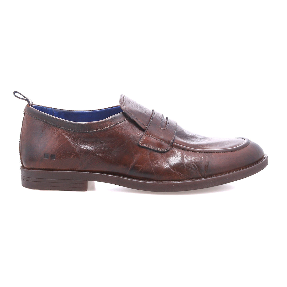 The Bed|Stü Lumaro is a brown distressed leather penny loafer featuring a low heel, visible stitching, and a classic penny slot detail, presented in a left side profile against a white background for a look of relaxed elegance.