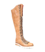 Lustrous knee-high hiker-style leather boot with lace-up front and rugged white sole by Bed Stu, isolated on a white background.