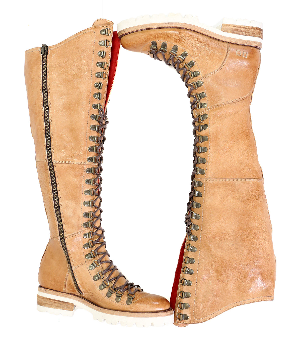 A pair of Lustrous tan leather knee-high hiker-style boots with laces and side zippers, displayed upright against a white background by Bed Stu.