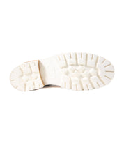 White rubber sole of a Lustrous hiker-style boot by Bed Stu with a traction pattern, isolated on a white background.