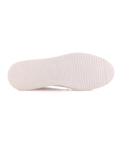 White rubber sole of a Lynox sneaker with a horizontal ribbed tread pattern.