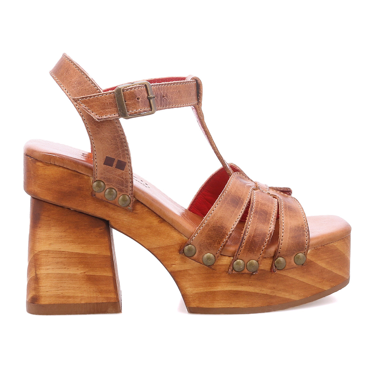The Bed Stu Lyxon is a brown leather platform sandal featuring an open toe, chunky wooden heel, metal rivets, and a buckled ankle strap, shown in side profile.