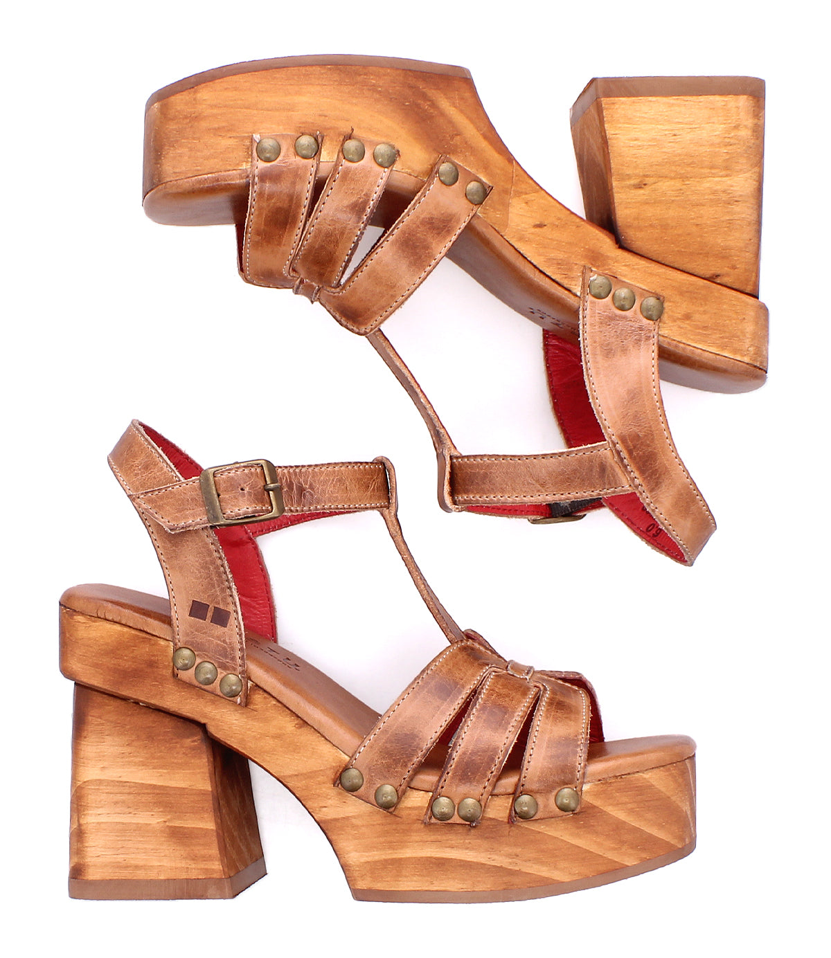 The Bed Stu Lyxon sandals are brown leather open-toe platforms with wooden chunky heels, brass studs, and red lining, shown side by side on a white background.