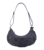 Introducing the Madre by Bed Stu—a black leather shoulder bag featuring a curved design and metallic rivets around the edges. This edgy piece infuses any outfit with a rock ‘n’ roll vibe.