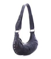 The Madre by Bed Stu is a black leather hobo bag with a thick strap and metal studs along the side, offering the perfect rock ‘n’ roll edge to add a statement-making touch.