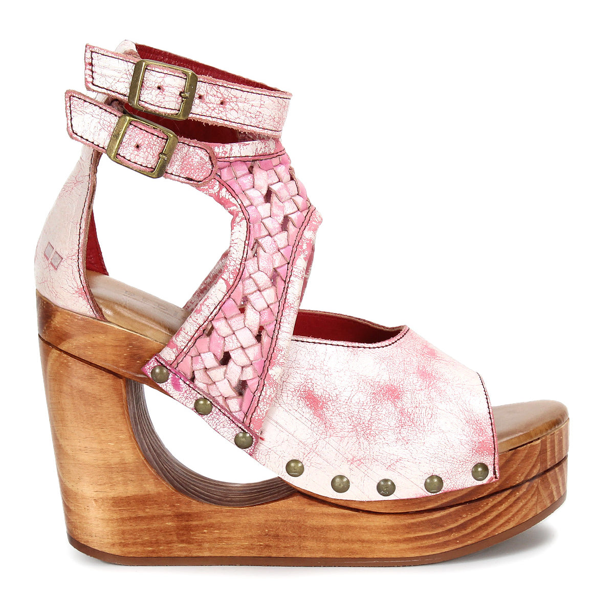 The Magic sandal by Bed Stu features a pink and white woven leather upper, double adjustable ankle straps with brass buckles, and a platform wooden wedge heel.