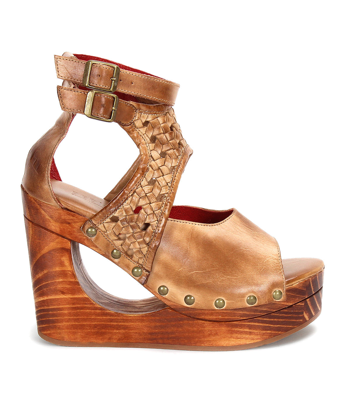 The Bed Stu Magic is a brown leather platform wedge sandal with a woven upper, adjustable buckle ankle strap, open toe, wooden base, and metal rivet accents.