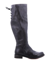 The Bed Stu Manchester is a tall black leather women's boot featuring a low heel, rounded toe, and lace-up detail at the upper back—an essential addition to any wardrobe.