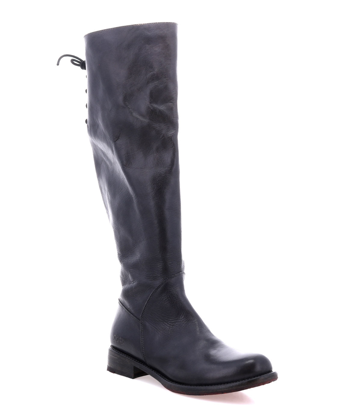 The Bed Stu Manchester is a black leather tall boot for women, featuring a low heel and lace-up detail at the back—perfect for timeless style and everyday versatility.