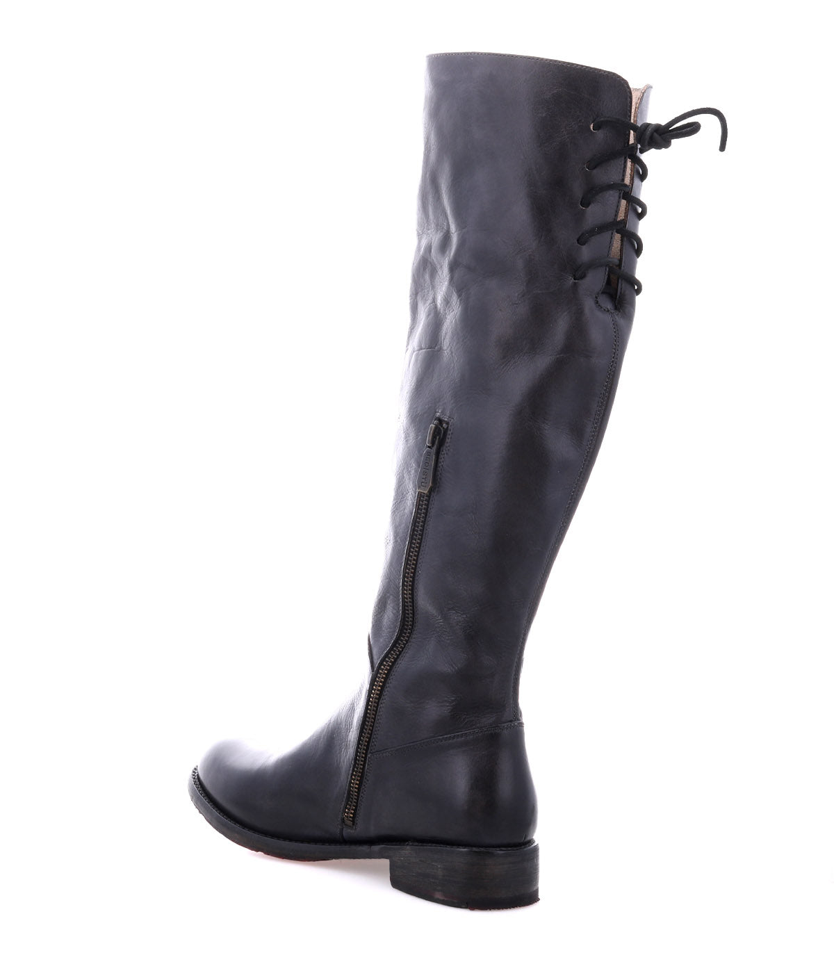 The Bed Stu Manchester is a tall black leather women’s boot featuring a side zipper and lace-up back detail, displayed against a white background—a must-have for any wardrobe.