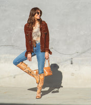 A woman wearing a Bed Stu Manchester boot and a leather jacket.