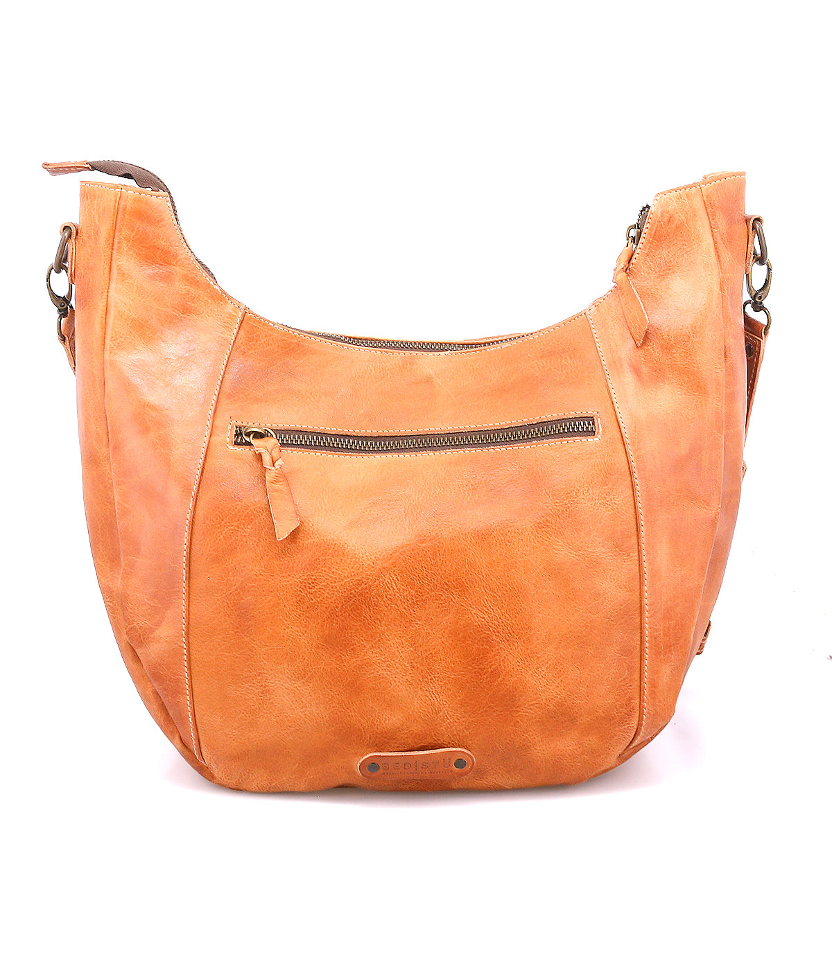 The Manitoba by Bed Stu is a light brown handcrafted bag with a zippered front pocket and adjustable strap, ideal for everyday wear and shown against a white background.