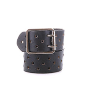 The Bed Stu Mccoy is a black vegetable-tanned leather belt featuring a silver rectangular buckle and multiple round holes, blending modern aesthetics with a timeless design.