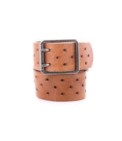 The Bed Stu Mccoy is a brown vegetable-tanned leather belt featuring a rectangular metal buckle and evenly spaced round holes, combining timeless design with modern style.