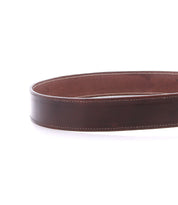 The Bed Stu Meander is a rugged belt made from brown distressed leather, featuring white stitching and an antique metal buckle, shown against a white background.