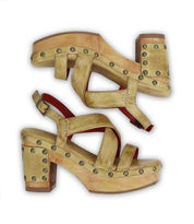 A pair of Bed Stu gold Mediation sandals with metal studs, offering ultimate comfort during serene moments.