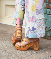 A person in Bed Stu comfortable pants engaged in Mediation, with the added convenience of wearing sandals.