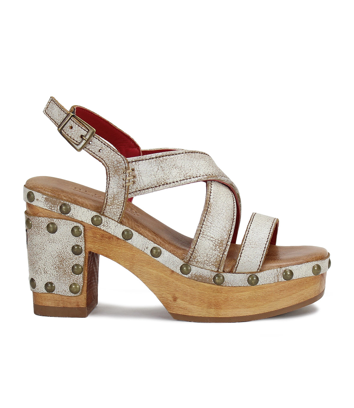 A single platform sandal with wooden soles studded with golden rivets, featuring white and red leather straps and a buckle closure, perfect for the fashionista looking to elevate her accessories game by Bed|Stü's 'Shop the Look' Bundle! 🌸