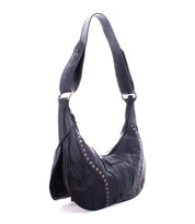 The Megara by Bed Stu is a chic black leather shoulder bag embellished with silver studs and a wide strap, showcasing elegant leather details.