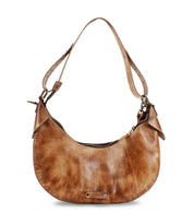The Megara by Bed Stu is a brown leather hobo bag featuring an adjustable strap and zipper closure, complemented by a metallic Bed Stu brand logo on the front. Crafted with fine leather details, this everyday companion effortlessly combines style and functionality.