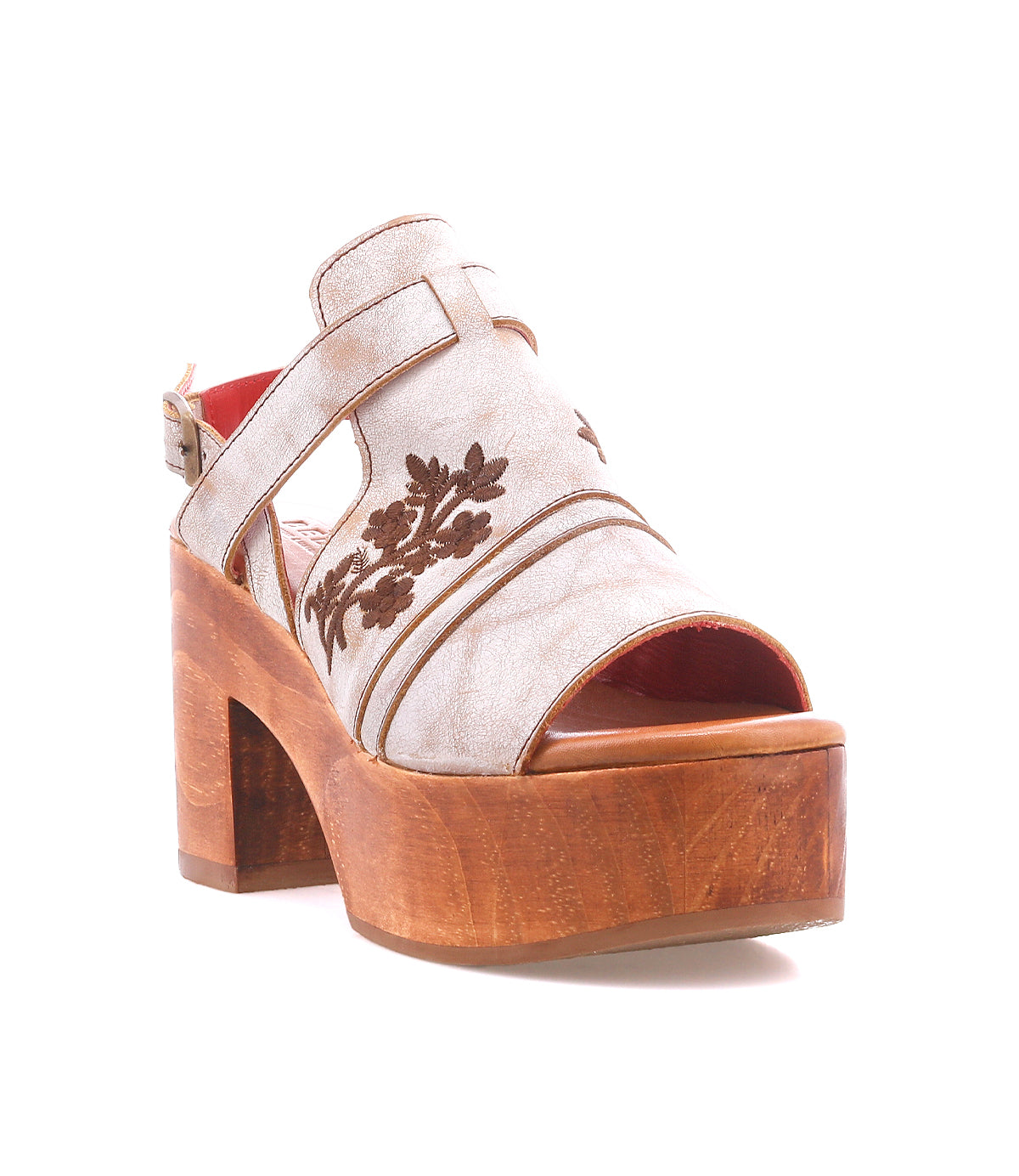 The Bed Stu Melodramatic is a platform sandal featuring a chunky leather heel, beige embroidered leather upper with floral details, open toe, back strap, and buckle closure.
