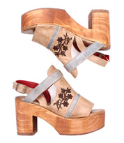 The Melodramatic by Bed Stu: platform sandals with chunky leather heels, beige leather straps accented with gray trim, and embroidered leather floral details on the upper.