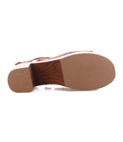 Bottom view of the Bed Stu Melodramatic sandal, showcasing a smooth sole, chunky leather heel with visible tacks, and detailed wooden construction.
