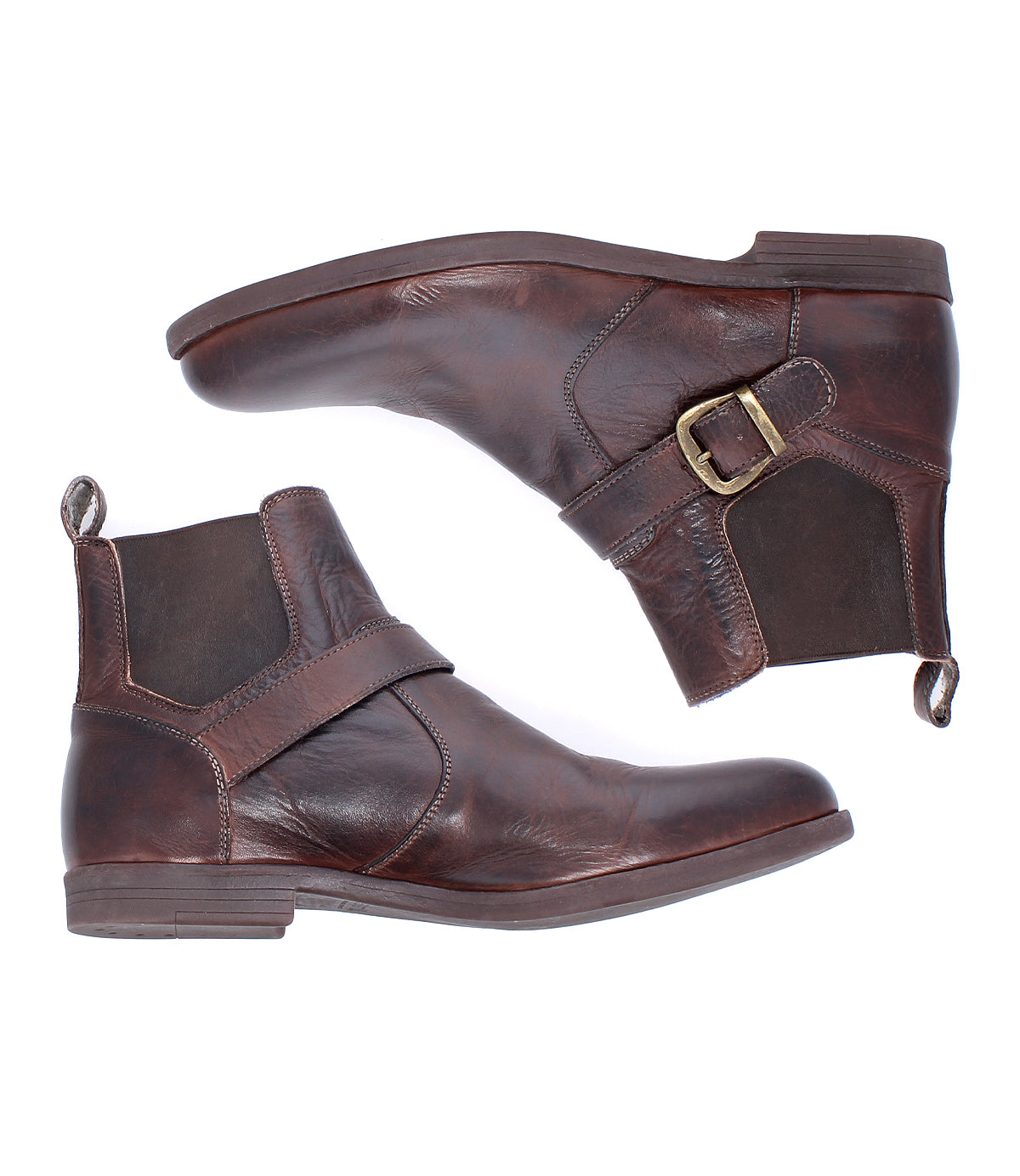 The Bed Stu Michelangelo is a pair of brown leather ankle boots with a buckle accent and low heels, featuring a durable rubber outsole, shown on a white background.