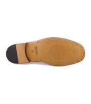 The image showcases the sole of a men's shoe with a tan leather finish, black heel, visible stitching, and text indicating 'Vero Cuoio' and size '43'. This classic loafer is the Moat by Bed Stu, handcrafted in Italy from high quality leather.