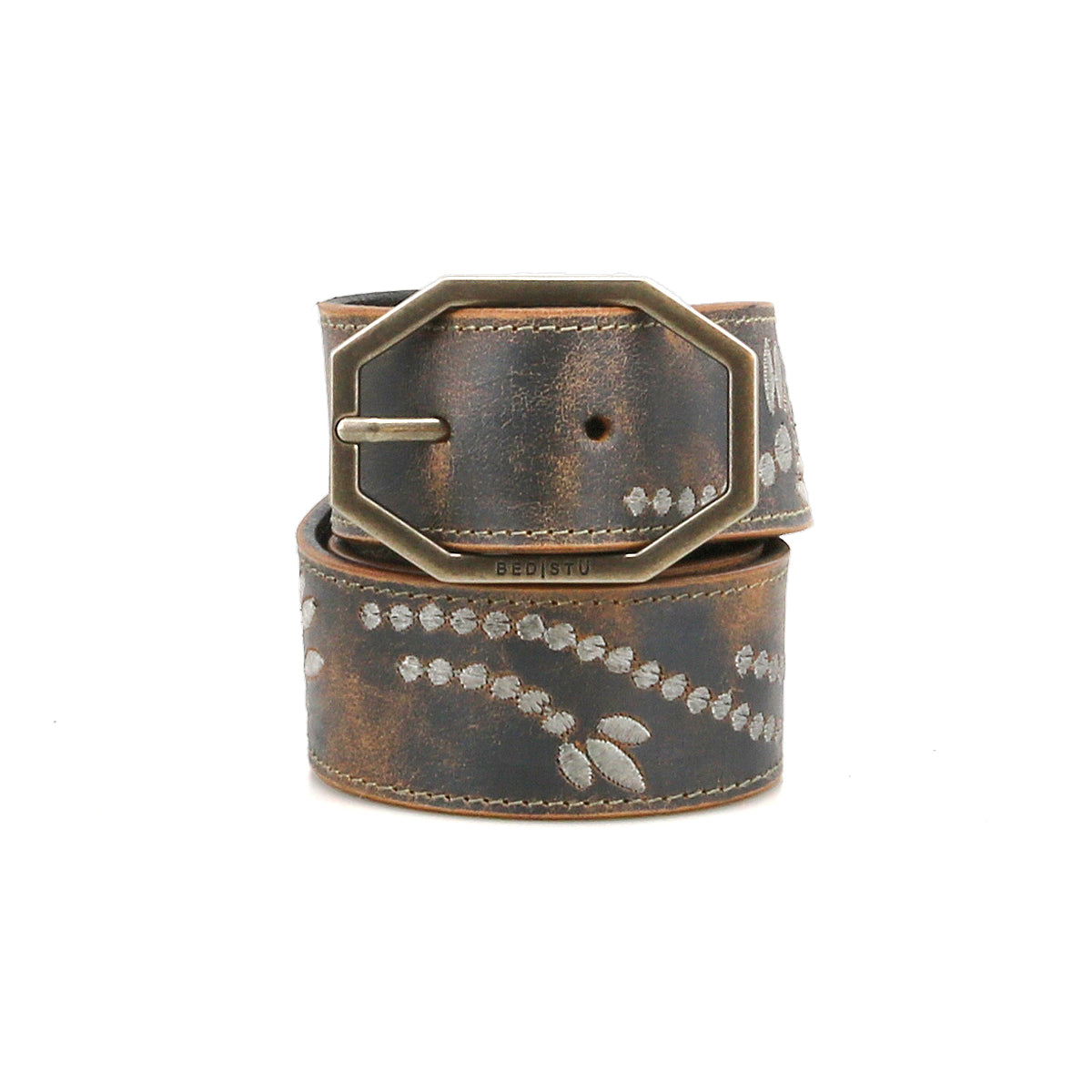 The Bed Stu Mohawk women’s belt features distressed leather, light leaf patterns, a weathered finish, and a large antique-style rectangular buckle for vintage-inspired charm.